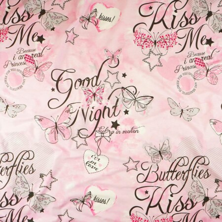 a pink comforter with black and white text